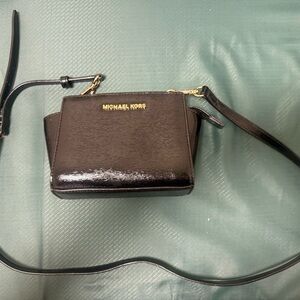 Michael Kors Selma Mini Messenger bag in black patent leather